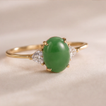 Oval Jade Three-Stone Ring with Trillion Cubic Zirconia in Yellow Gold Tone