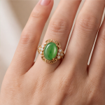 Oval Jade Cabochon Ring with Scrolled Gold Frame and Cubic Zirconia Clusters - Image 2