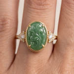 Oval Carved Green Jade Ring with Trillion Cubic Zirconia Shoulders in Gold Tone - Image 2