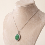 Oval Carved Green Jade Halo Pendant in Sterling Silver