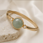 Oval Green Jade Cabochon Hinged Bangle in Gold Tone